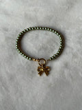 Armband goud/groen strikje