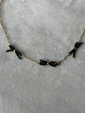 Ketting goud/zwart strikjes