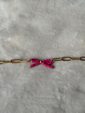 Armband goud/roze strikje